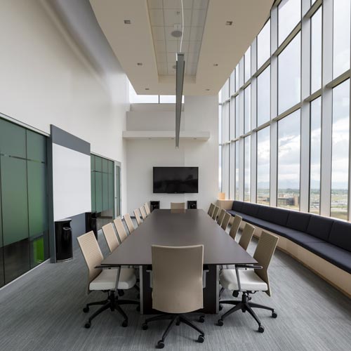 Conference room in a high rise office building with new white paint on walls and light gray flooring
